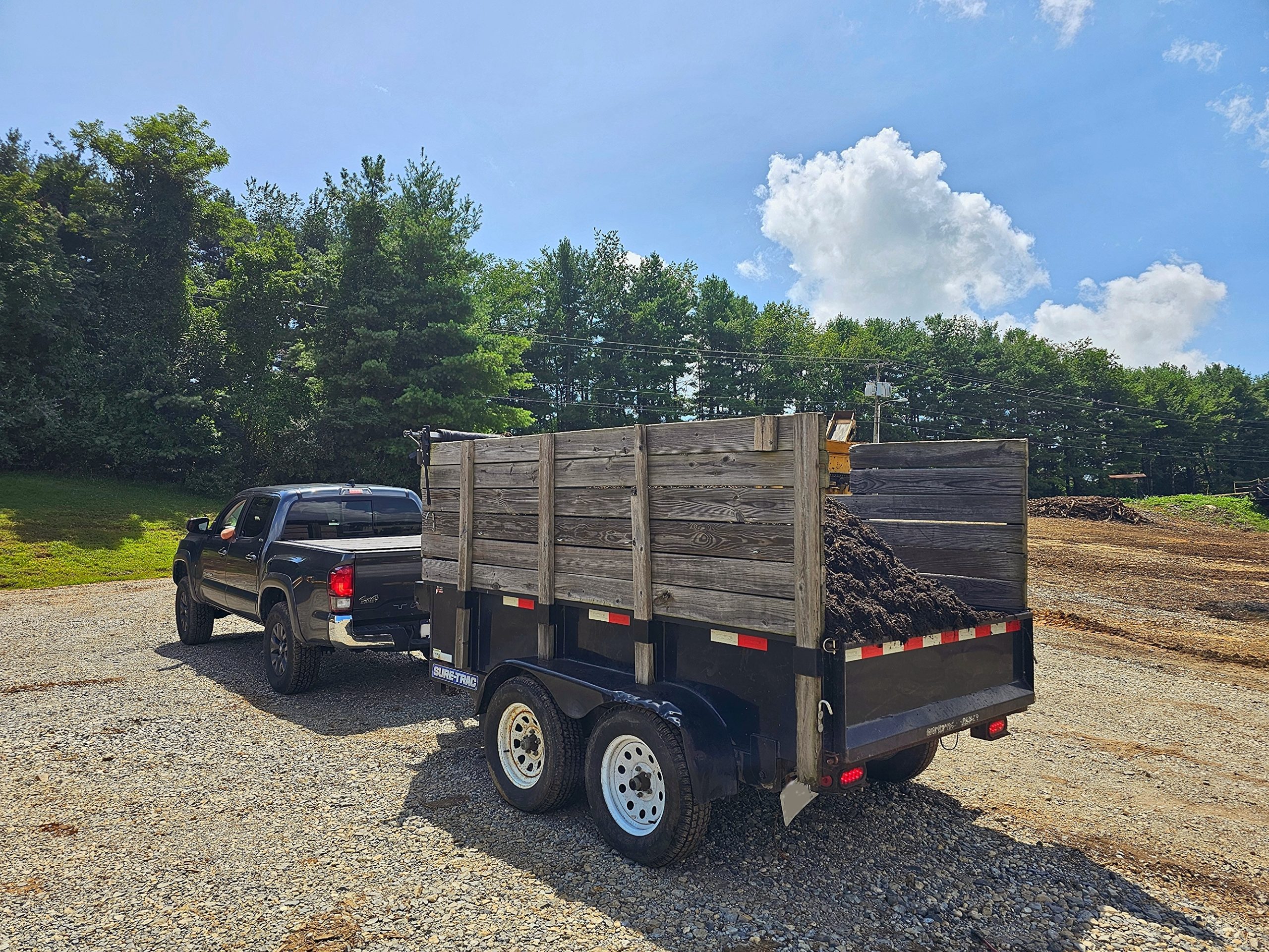 Blackberry Mulch Onsite Pickup by Homeowner Homeowner picking up bulk hardwood mulch with trailer at Blackberry Mulch—onsite pickup available, no appointment needed in Radford VA